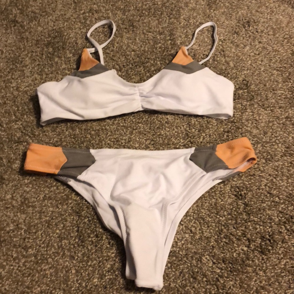 White swimsuit with peach and grey